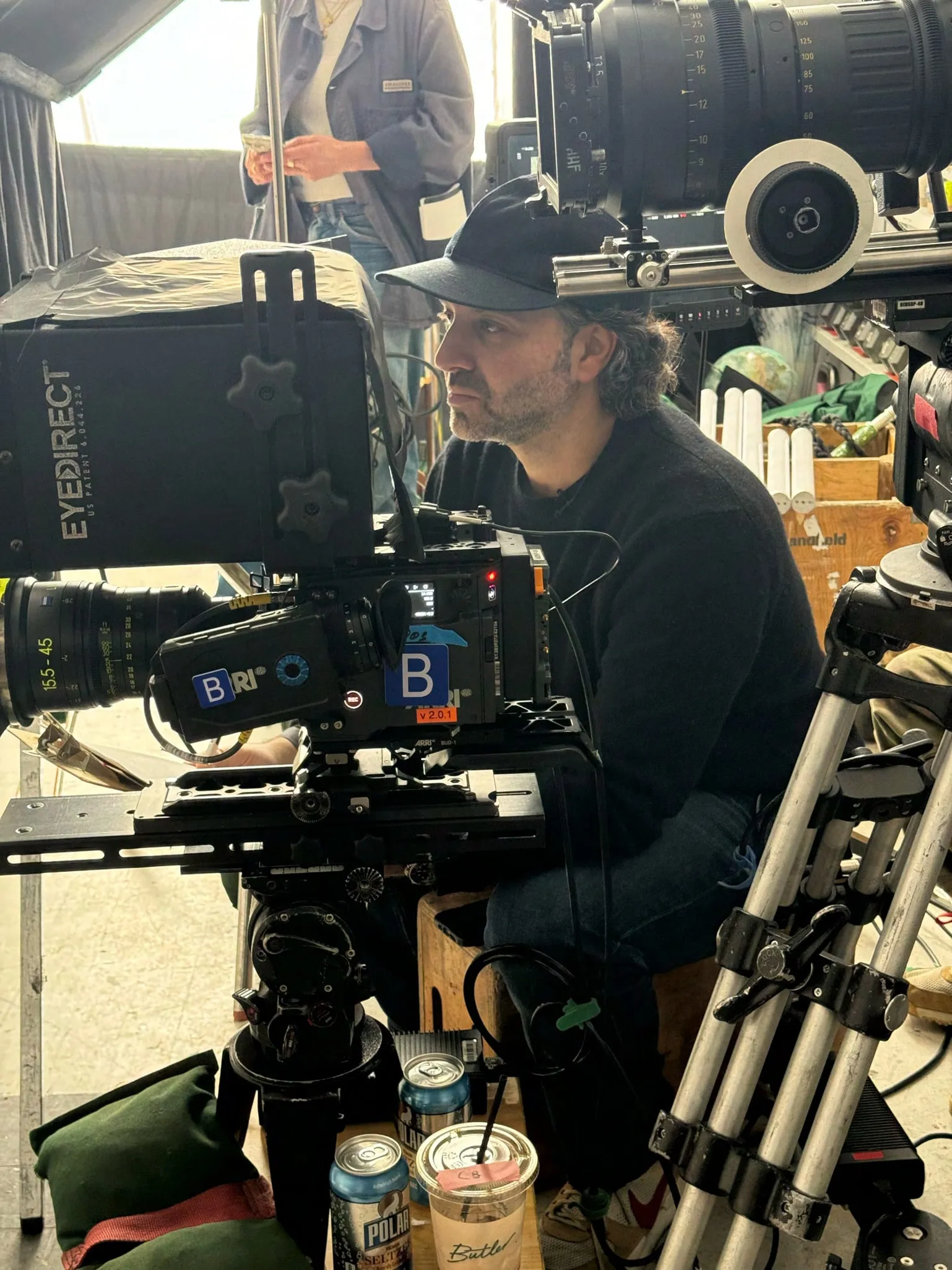 Howie Kahn on set, seated behind a cinema camera