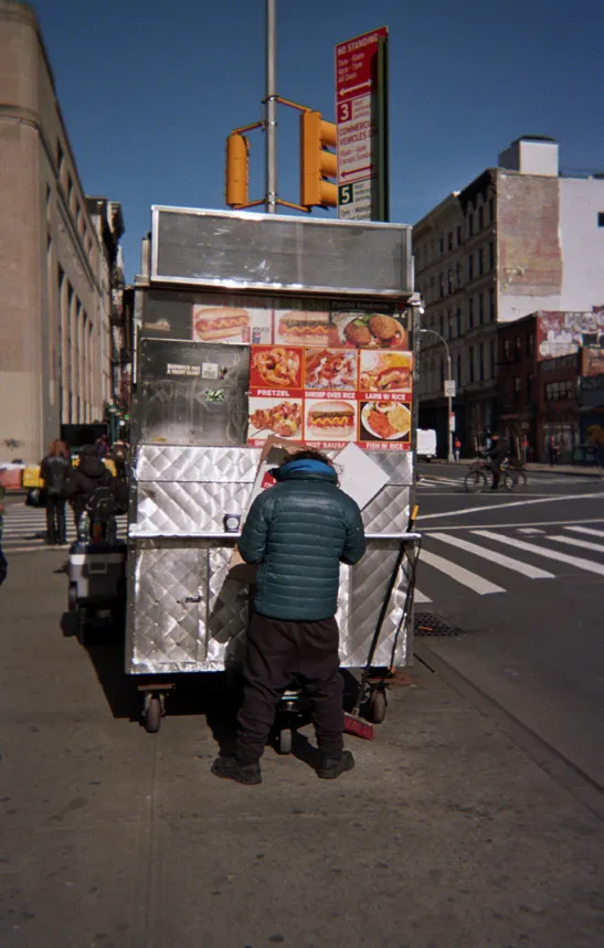 Cart vendor working at a New York coffee cart on the street