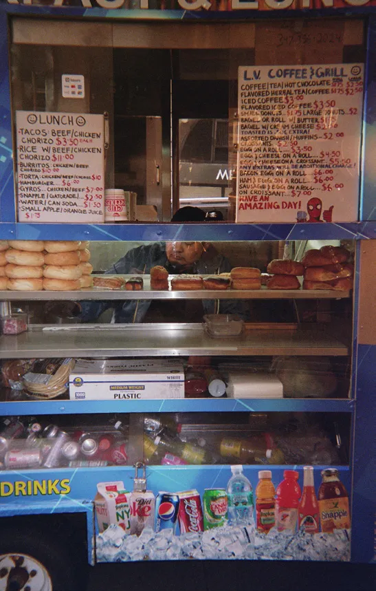 L.V. Coffee & Grill menu and pastry case in a New York coffee cart